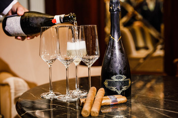 wine and cuban cigars are on the table