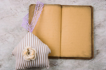 top view vintage old paper,pencil and stuffed toy house on a stone marble  background