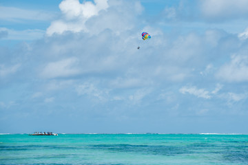 Parasailing on tropical beach in Indian Ocean