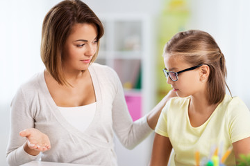 education, family and learning concept - displeased mother talking to daughter while doing homework at home