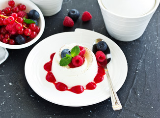 Delicious Italian dessert panna cotta with berries and berry sauce. Valentine's Day.