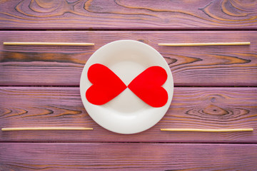 Love heart on a plate. The concept of nutrition love, heartwarming, losing weight because of love.