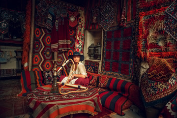 Girl in old carpet shop in Cappadocia