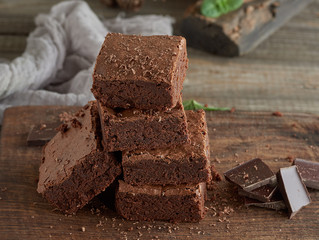 stack of square pieces of baked brown brownie pie