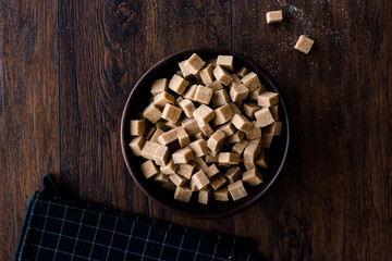 Raw Organic Brown Sugar Cubes in Wooden Bowl Ready to Eat.