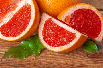 Naklejka na ściany i meble Grapefruit with slices on a wooden table.