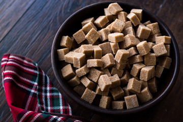 Raw Organic Brown Sugar Cubes in Wooden Bowl Ready to Eat.