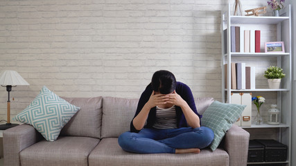 Girl in despair covers her face with hands