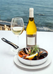 A dish of mussels on the background of the sea