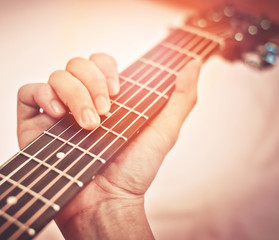 Guitar player / Hand man playing acoustic guitar in chord tab - guitar fretboard