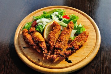 Red mullets (Mullus barbatus) fried in bread crumbs and served with green salad and lemon