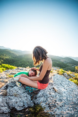 Naklejka premium The tired boy lies on his mother's feet.