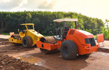 road construction with road roller / yellow and orange modern tractor roller dual working