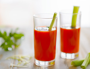 Tomato juice and celery on the table
