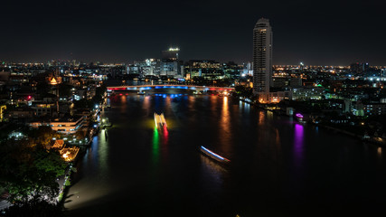 Fototapeta na wymiar Bangkok cityscape. Bangkok night view riverside from rooftop