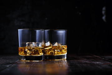 whiskey with ice in modern glasses