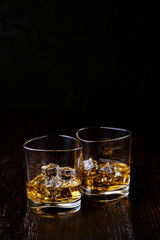 whiskey with ice in modern glasses