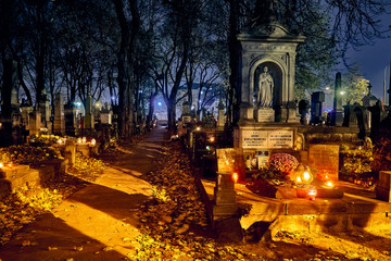 Memento mori - lights and graves on All Saints' Day in the Powazki Cemetery (Polish: Cmentarz...