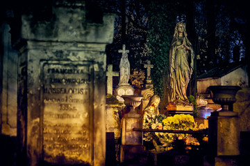 Memento mori - lights and graves on All Saints' Day in the Powazki Cemetery (Polish: Cmentarz...