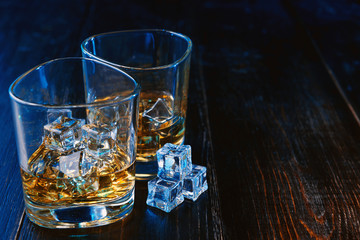 whiskey with ice in modern glasses