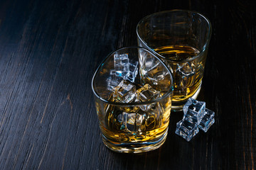 whiskey with ice in modern glasses