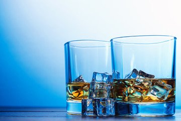 whiskey with ice in modern glasses