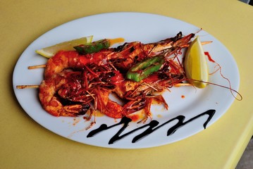 Black sea prawns cooked in hot chili sauce and served with lemon in Sochi, Russia