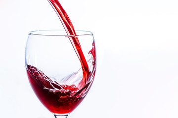 Close up of Red Wine Pouring Into Glass on light background, Alcohol abuse and alcoholism, celebration and party concept. With copy space.
