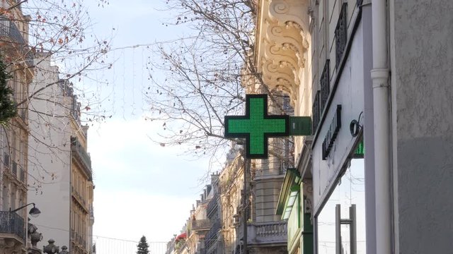 Paris France pharmacy cross shining led green signboard