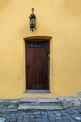 Old door on the façade of stone building