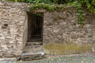 Old door on the façade of stone building
