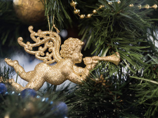 Golden angel trumpeting, beautiful decoration on the Christmas tree.