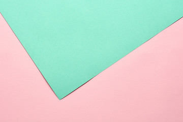 Green and pink pastel color paper geometric flat lay background