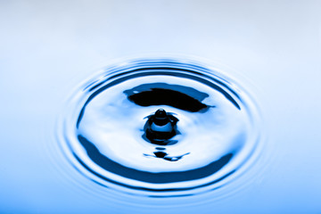 Blue water droplets on a shiny surface