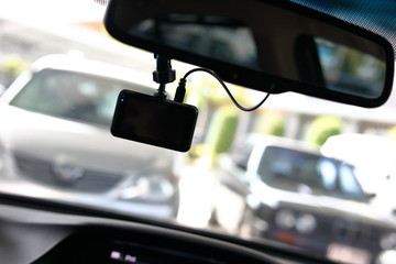 driving car with video camera record technology on windscreen