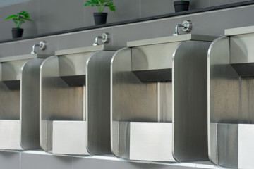 Public male bathroom is made of stainless steel for ease of cleaning, easy to produce, not broken. Concept of health, cleanliness