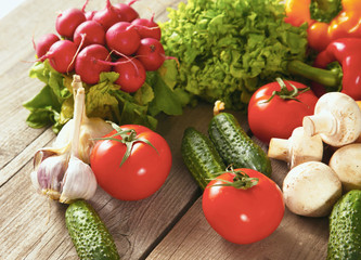 Composition with assorted raw organic vegetables wooden table