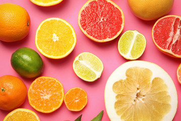 Fototapeta na wymiar Different citrus fruits on color background, top view