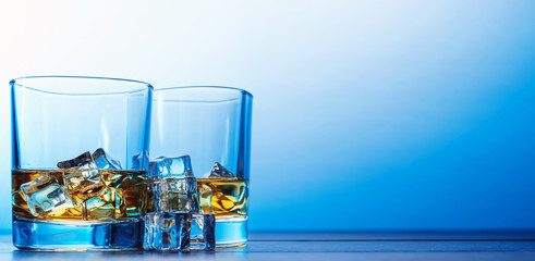 whiskey with ice in modern glasses