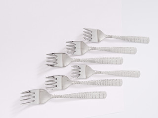 silverware forks spoons knives cutlery on a white background