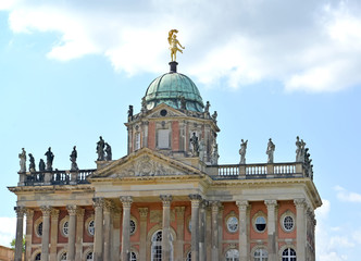 Fototapeta na wymiar POTSDAM, GERMANY. A dome and a frieze of the New palace against the background of the sky. Park of San Sushi
