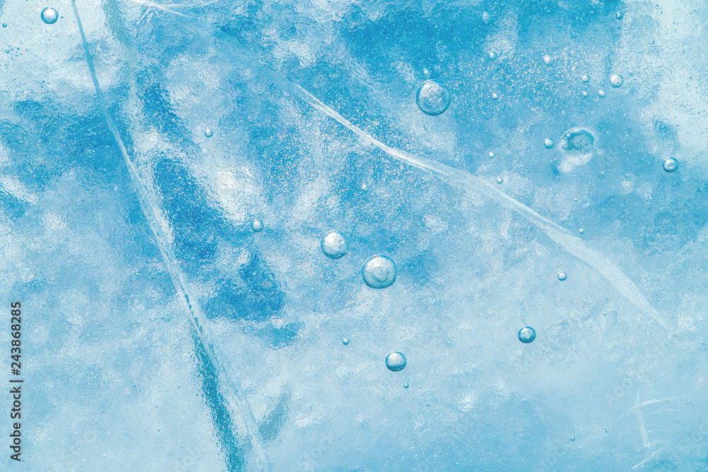 Wall mural abstract ice background. blue background with cracks on the ice surface