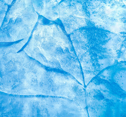 Abstract ice background. Blue background with cracks on the ice surface