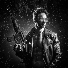 Fototapeta na wymiar A man in a leather jacket and glasses poses with an automatic rifle.