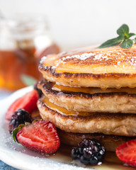 Delicious home made pancakes with honey and strawberries