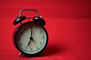 Clock ticking to 7 o'clock on the red background