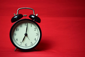 Clock ticking to 7 o'clock on the red background