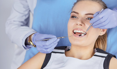 beautiful girl in the dental chair on the examination at the de