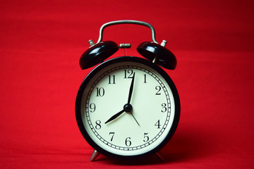 Clock ticking to 8 o'clock on the red background