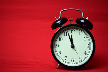 Clock ticking to 12 o'clock on the red background